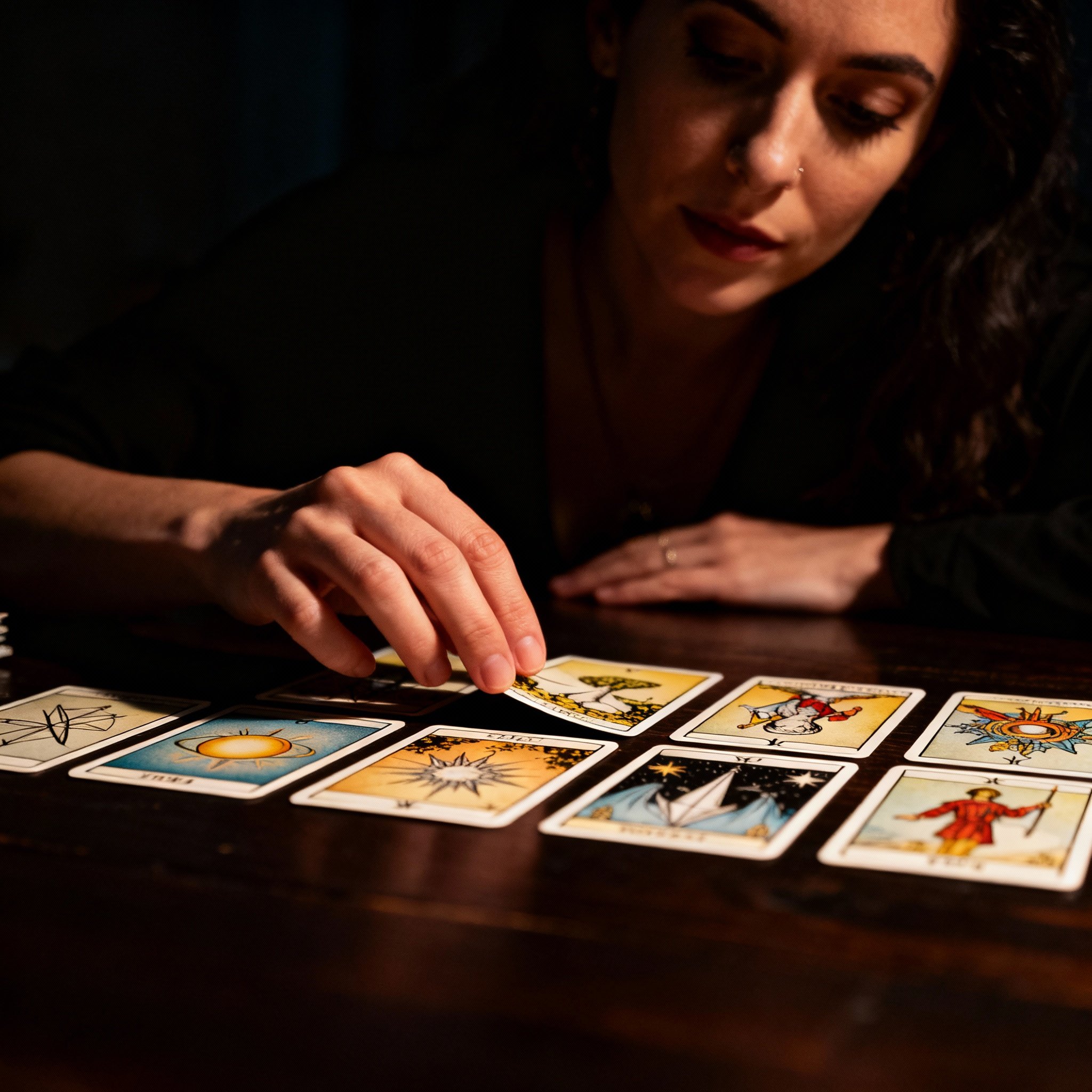 A scene of psychic Avea intently interpreting tarot cards, with cards spread on the table and dramatic light focused on the cards, creating an atmosphere of focus and epiphany.