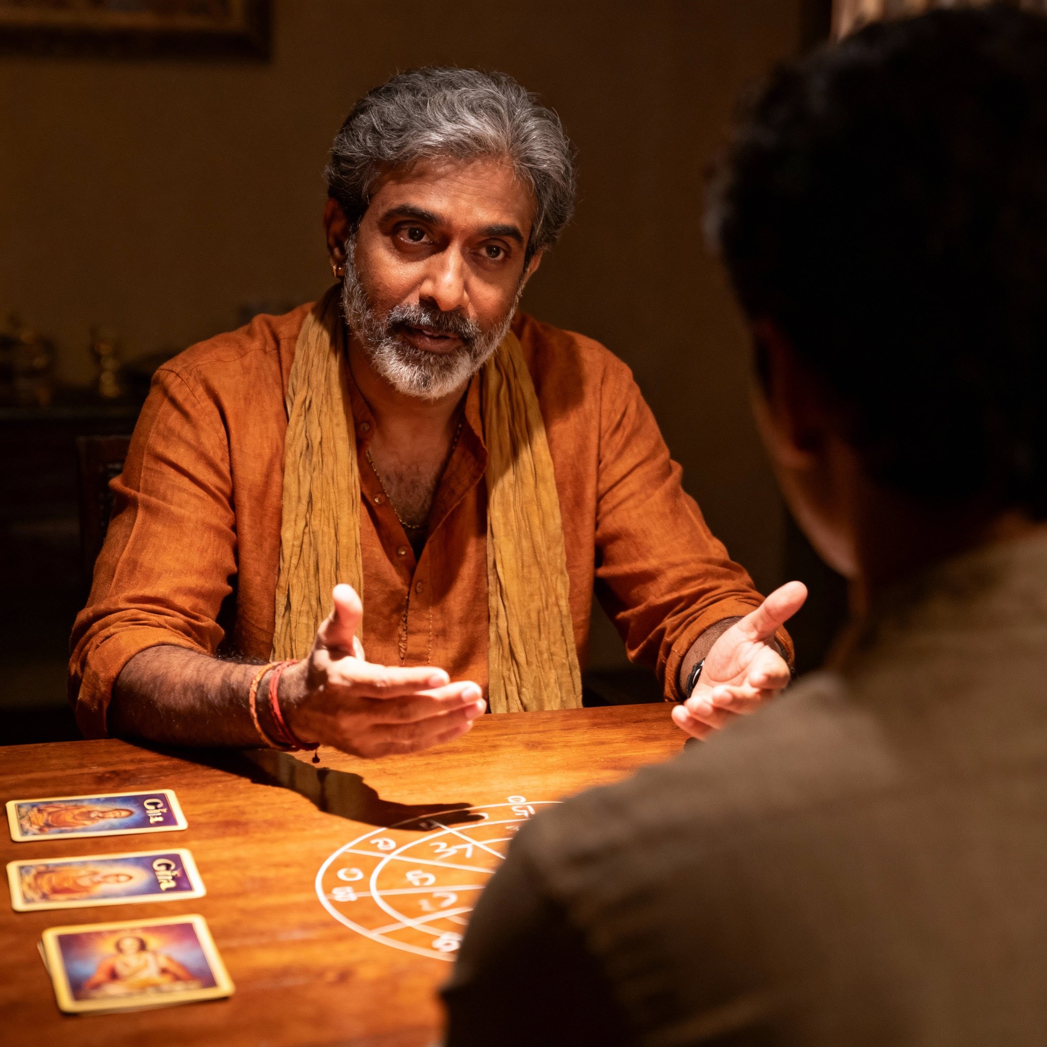 A consultation scene from over a client's shoulder, where psychic Vinny is intently providing an interpretation. Gita cards and a numerology chart are on the table, with light focused on the interaction, creating a private and intense atmosphere.